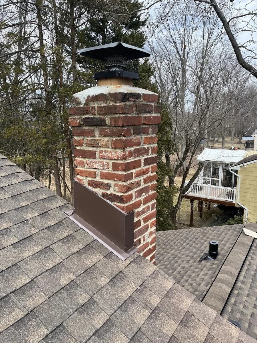 Brick chimney with new dark flashing on Barkwood shingled roof — Cherry Hill Township