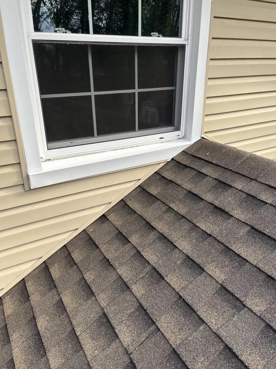Detail of new GAF Timberline HDZ Barkwood shingles meeting siding at second-story window — Cherry Hill Township