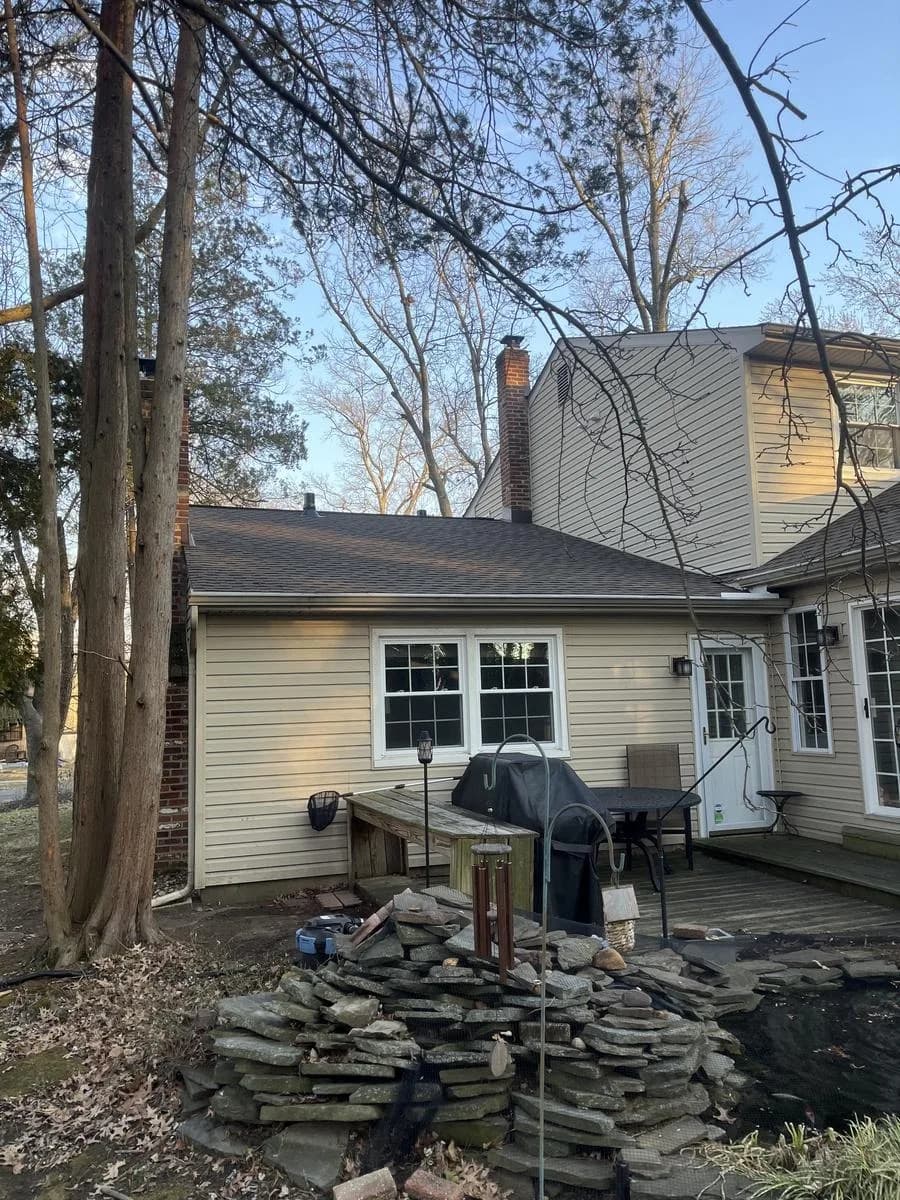 Rear elevation showing new roof, chimney, and patio area — Cherry Hill Township