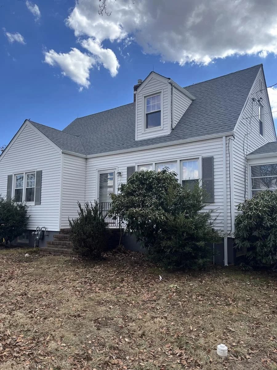 Cape-style home front elevation with new GAF Timberline HDZ Oyster Gray roof — Hillsborough Township