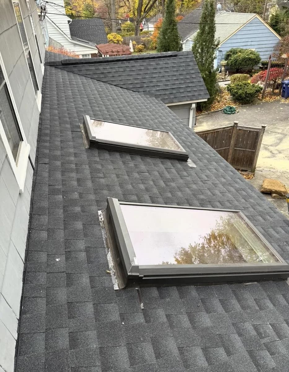 Two new VELUX fixed skylights set into GAF Timberline HDZ Charcoal roof — Montclair