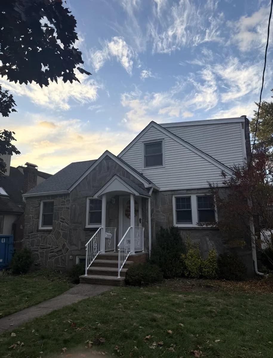 Front elevation of Nutley home with new GAF Timberline HDZ Pewter Gray roof and rebuilt brick chimney