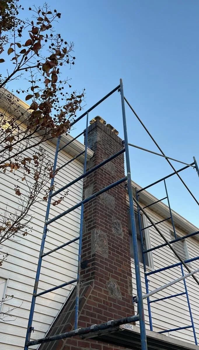 Top-of-chimney detail showing fresh mortar joints — Nutley repointing