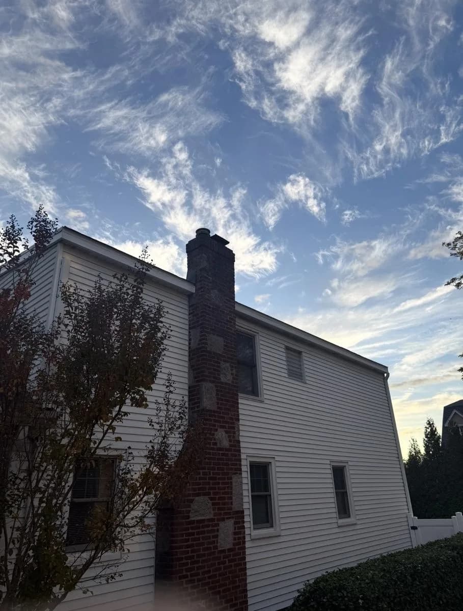 Rear of home with rebuilt brick chimney and new shingled roof — Nutley