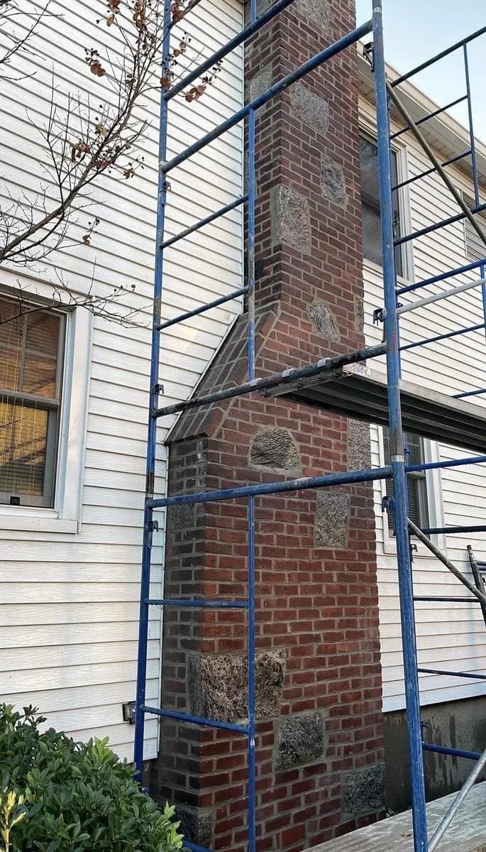 Mid-project chimney repointing — scaffold view of brick joints being recemented — Nutley