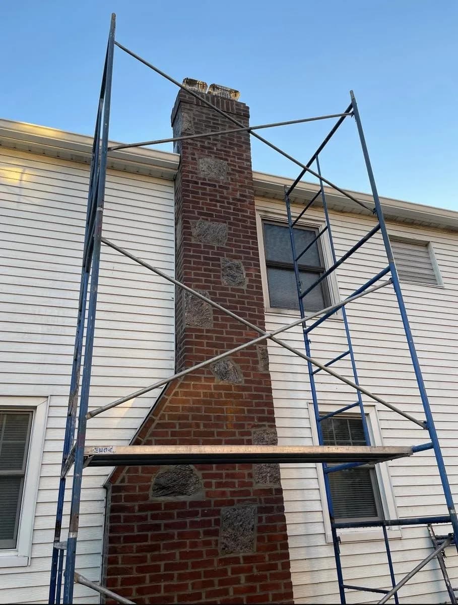 Top section of chimney with completed repointing visible — Nutley