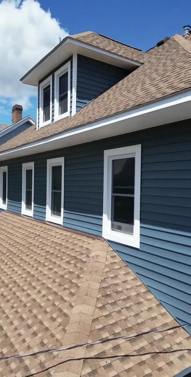 Side detail of dormer with new Pacific Blue siding and shingled roof — New Rochelle