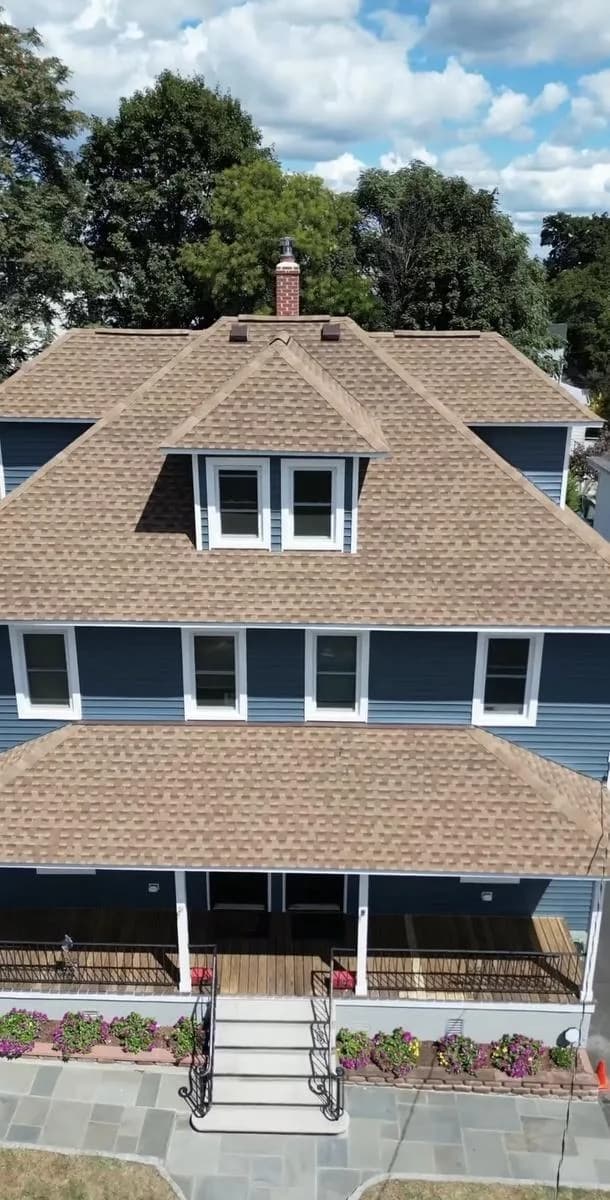 Aerial roof view showing new shingles, dormer, and chimney — New Rochelle