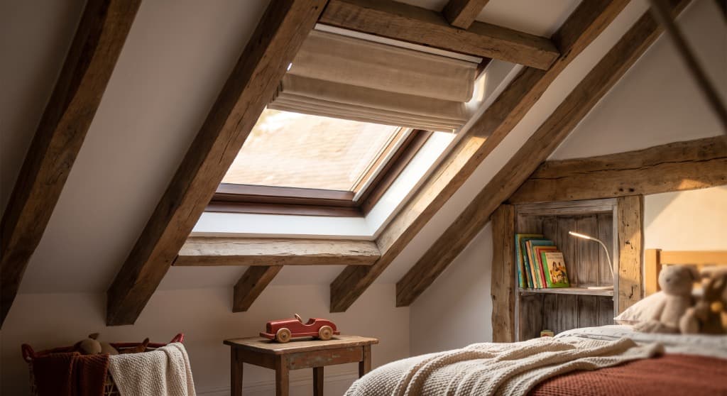 Children's room with cozy skylight and wood beams